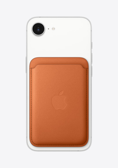 På baksiden av en iPhone 17e i fargen hvit vises Fusion-kameraet oppe i det ene hjørnet og en MagSafe-lommebok i finvev i fargen reverød.